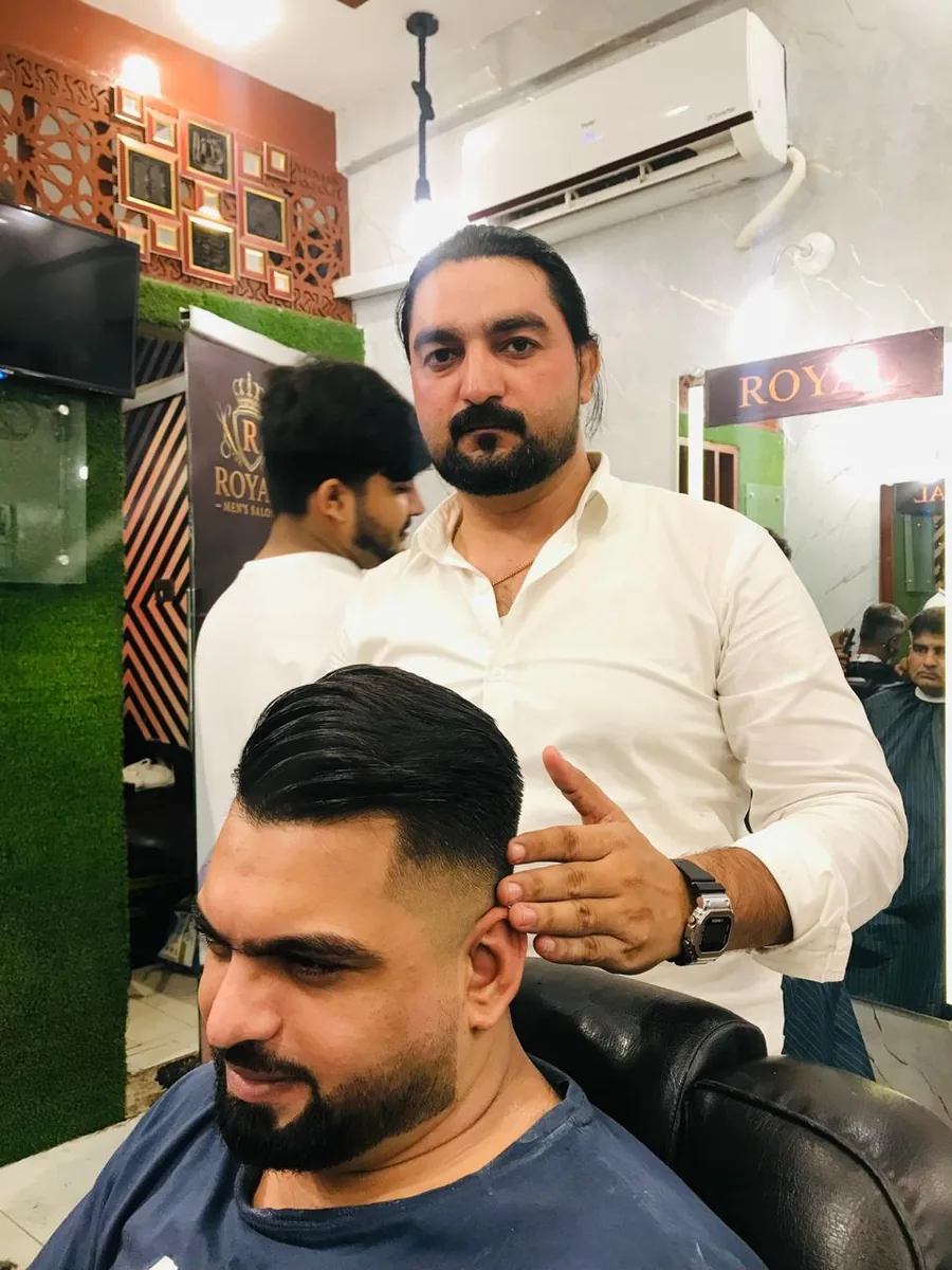 Muhammad Irfan styling a client at Royal Men's Salon